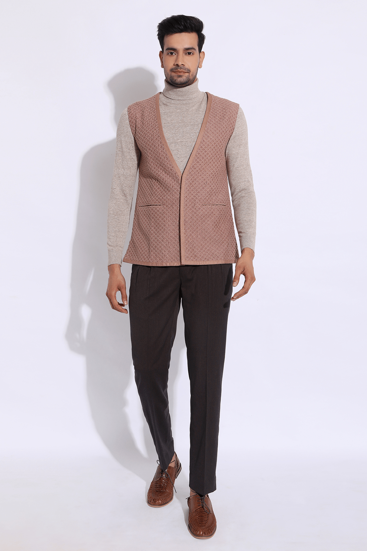 Beige textured long waist coat jacket with beige polo neck and brown trousers - Kunal Anil Tanna