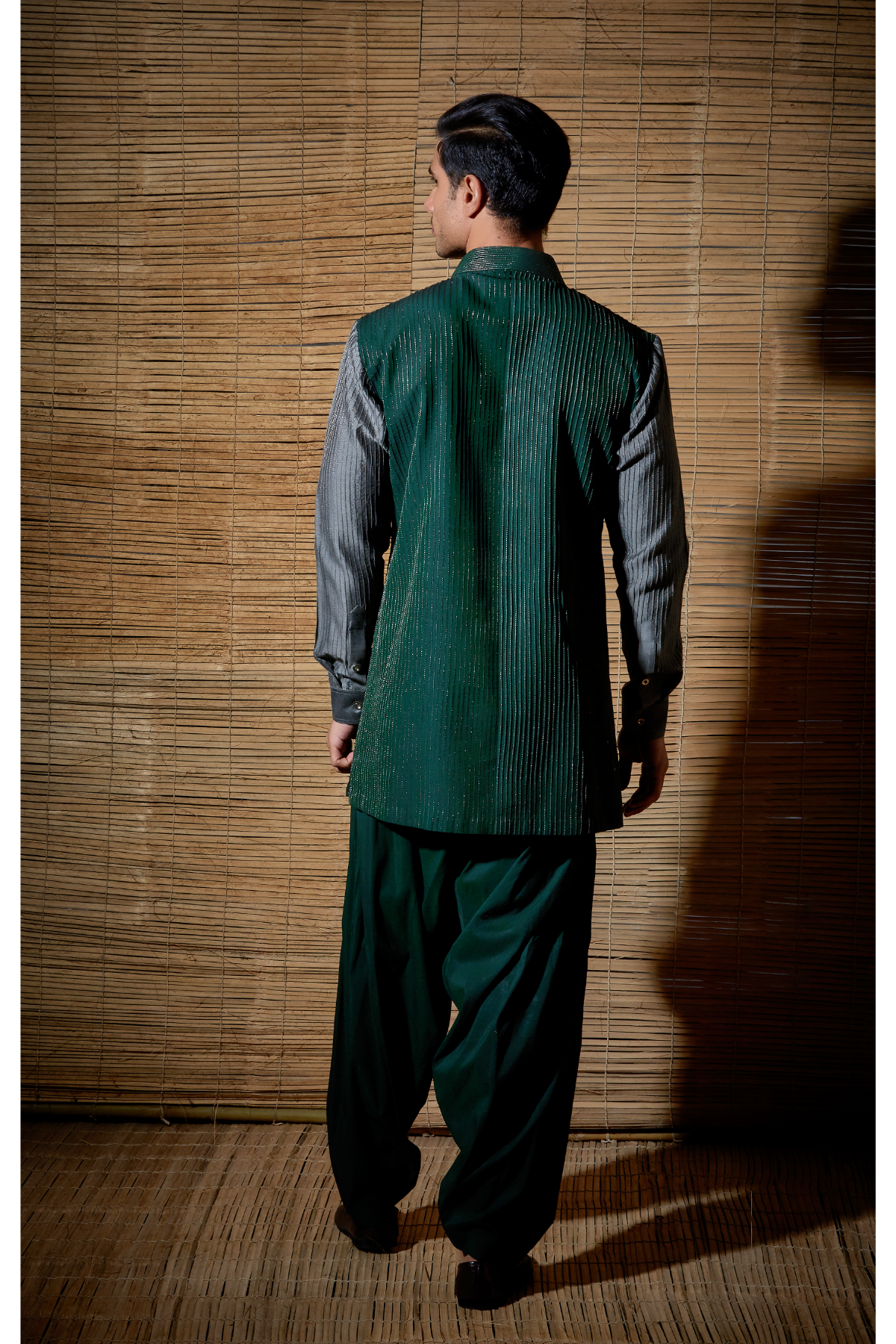 Dark green textured kurta with grey sleeves paired with salwar