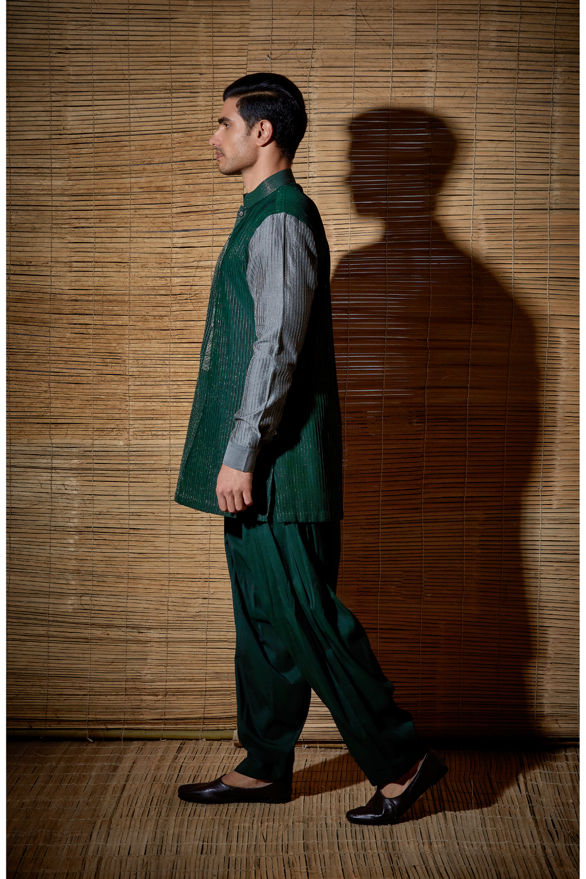 Dark green textured kurta with grey sleeves paired with salwar