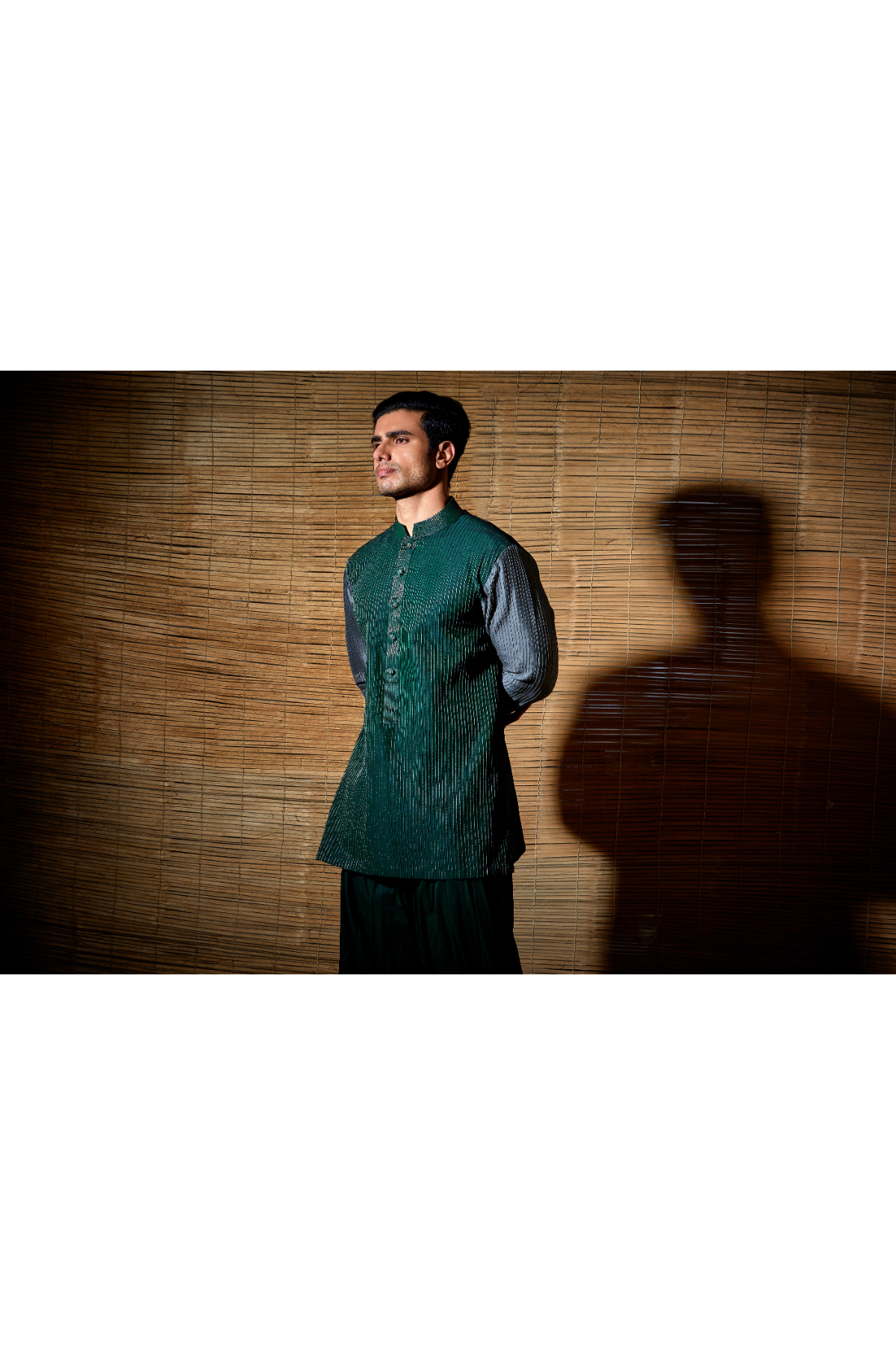 Dark green textured kurta with grey sleeves paired with salwar