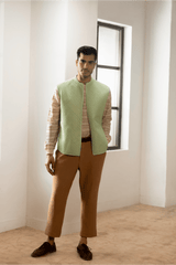 Green textured jacket with cream pullover and beige pants. - Kunal Anil Tanna