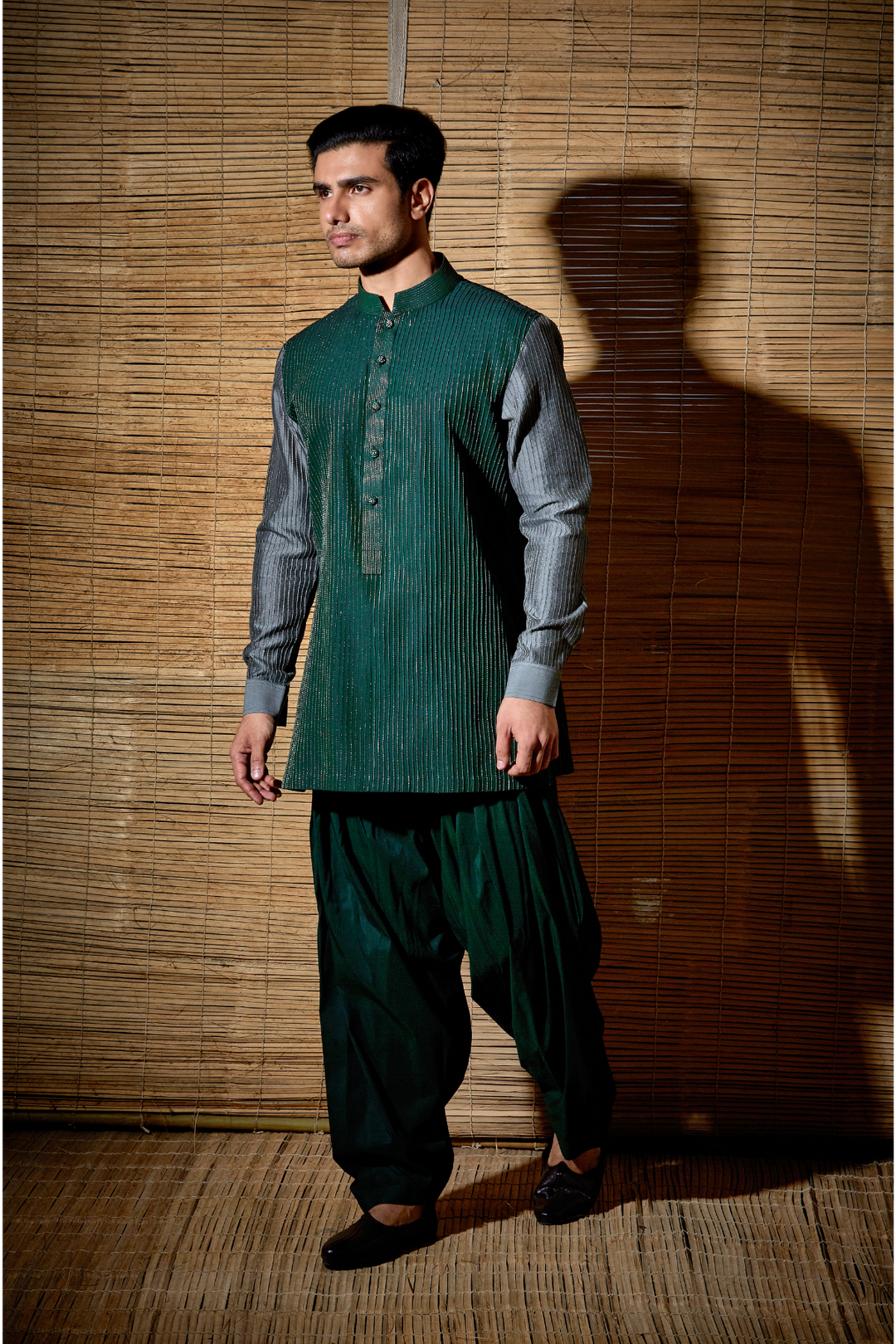 Dark green textured kurta with grey sleeves paired with salwar