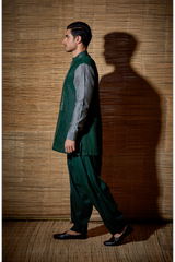 Dark green textured kurta with grey sleeves paired with salwar