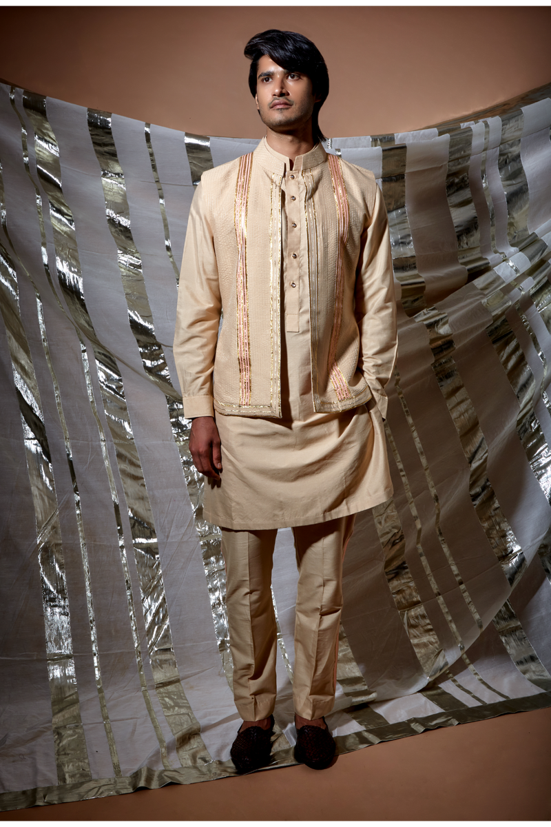 Beige zari textured bandi jacket with peach detail paired with kurta and pyjama pants - Kunal Anil Tanna